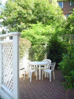 Private courtyard with outdoor furniture of a three bedroom apartment