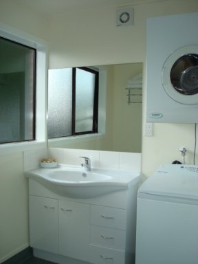 Laundry facilities in one of the bathrooms of a three bedroom apartment